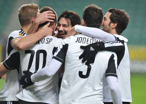 WARSAW, POLAND - DECEMBER 11: Players of Legia Warsaw celebrate after scoring during the UEFA Europa League Group L football match between Legia Warsaw and Trabzonspor AS at Polish Army Stadium, also known as Pepsi Arena, in Warsaw, Poland on December 11, 2014. (Photo by Cuneyt Karadag/Anadolu Agency/Getty Images)