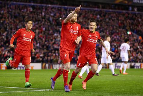 LIVERPOOL, ENGLAND - FEBRUARY 25: James Milner (C) of Liverpool celebrates scoring his team's first goal with his team mates Roberto Firmino (L) and Philippe Coutinho (R) during the UEFA Europa League Round of 32 second leg match between Liverpool and FC Augsburg at Anfield on February 25, 2016 in Liverpool, United Kingdom. (Photo by Clive Brunskill/Getty Images)